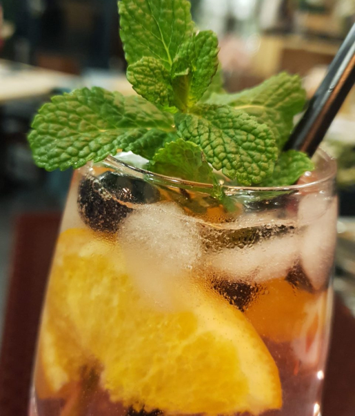 Sommer Spritz mit Orange, Beeren, Eiswürfeln und frischer Minze im Wirtshaus Ausspann´